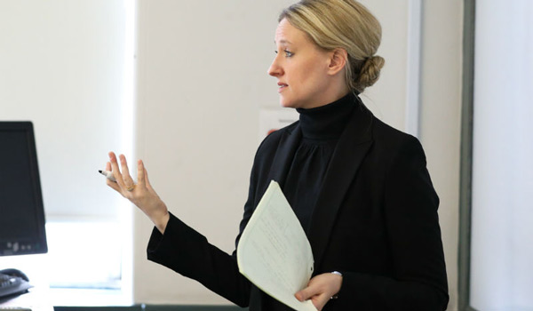 A Catholic ҽ professor teaching a class.
