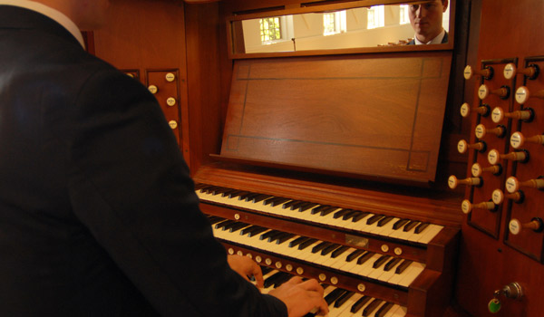 A Catholic ҽ student practicing the organ.